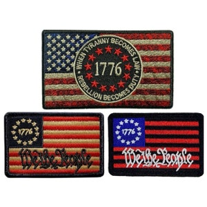 May include: Three embroidered patches with American flag designs. The top patch features a red, white, and blue American flag with a circle in the center that reads "When Tyranny Becomes Law, Rebellion Becomes Duty. 1776". The two bottom patches feature a red, white, and blue American flag with the text "We the People" and "1776" in the top left corner.