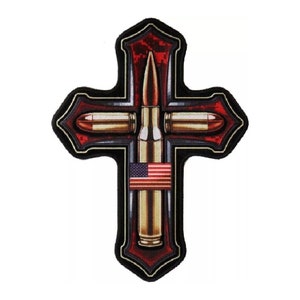 May include: A red and black cross with a camouflage pattern and three gold bullets. The bullets are arranged in a cross shape with an American flag in the center.