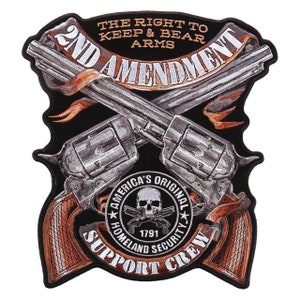 May include: A black embroidered patch with a crossed pair of silver revolvers, a banner reading "2nd Amendment", and a skull with crossed bones in a circle with the text "America's Original Homeland Security 1791 Support Crew".