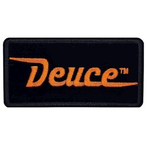 May include: Orange embroidered "Deuce" logo patch on a black background. The patch has a stitched border.