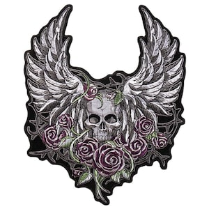 May include: A black and white embroidered patch featuring a skull with wings and roses. The skull is surrounded by thorns and roses. The wings are spread out behind the skull. The roses are purple and green.
