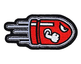May include: Red and white embroidered iron-on patch of a cartoon bullet with an angry face and a clenched fist.