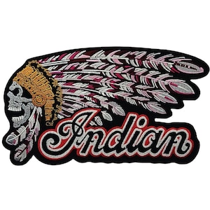 May include: Embroidered patch with a skull wearing a pink and white feathered headdress. The word "Indian" is written in a stylized font below the headdress.