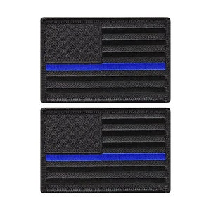 May include: Two black embroidered patches with a thin blue line across the middle of the American flag design.