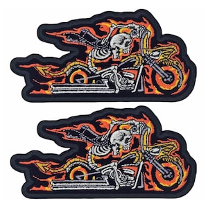 May include: Two embroidered patches featuring a skeleton riding a motorcycle with flames. The patches are black with orange, yellow, and white embroidery.