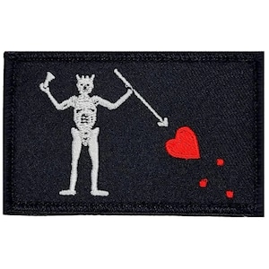 May include: Black embroidered patch with a white skeleton holding a sword and a spear, a red heart with blood drops, and the text "Jolly Roger".