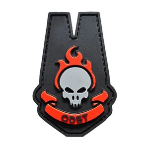 May include: Black and orange embroidered patch with a skull in flames and the text "ODST".