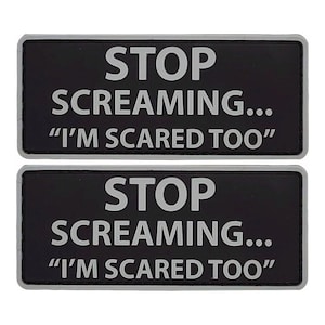 May include: Two black rectangular patches with white text that reads "STOP SCREAMING... "I'M SCARED TOO".