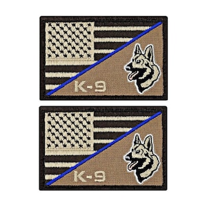 May include: Two embroidered patches with a brown background, a tan American flag with a blue diagonal stripe, and a black and white German Shepherd head. The text "K-9" is embroidered in white below the flag.