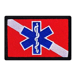 May include: A rectangular patch with a red background, a white diagonal stripe, and a blue star of life emblem. The star of life has a white staff with a snake. The patch is bordered with black.