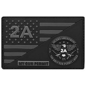 May include: A black rectangular patch featuring a stylized American flag design with the text "2A". The patch also includes a circular emblem with the words "SECOND AMENDMENT" and "THE ONLY GUN PERMIT I NEED". The text "MY GUN PERMIT" is also present.