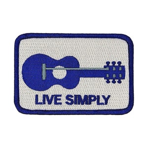 May include: Blue embroidered patch with a white background. The patch features a blue silhouette of an acoustic guitar and the text "LIVE SIMPLY".
