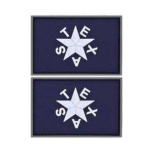 May include: Two blue and gray fabric patches with a white five-pointed star and the letters "TEXAS" surrounding the star.