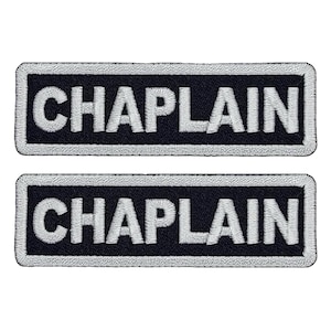 May include: Two black embroidered patches with white lettering that reads "CHAPLAIN".