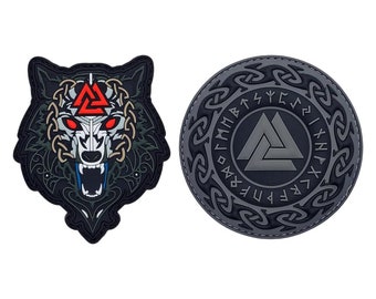 May include: Two black and gray embroidered patches. One patch features a wolf's head with a red and white triangle symbol. The other patch features a circle with a gray triangle symbol and black runes around the edge.