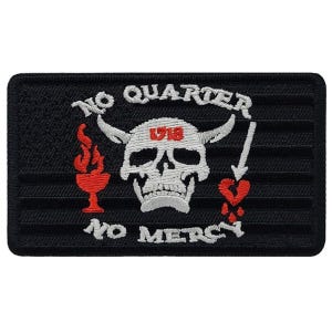 May include: Black embroidered patch with a white skull with horns, a red heart with an arrow through it, and a red goblet with flames. The text "NO QUARTER NO MERCY" is written in white around the skull.