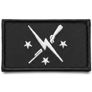 May include: Black rectangular patch with white embroidered design. The design features a lightning bolt, crossed with a pen and a rifle, and three stars. The patch has a black border.