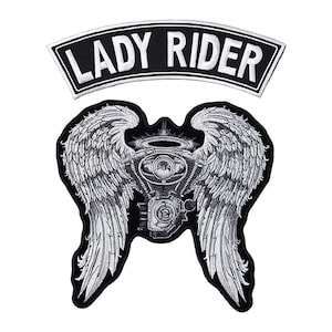 May include: Black and white embroidered patch with a motorcycle engine with angel wings and the text "LADY RIDER" on a separate patch.