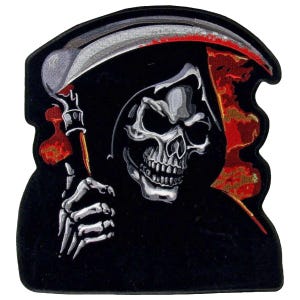 May include: Black and red embroidered patch featuring a skull with a hooded cloak and a scythe. The skull has a menacing expression and is surrounded by flames.