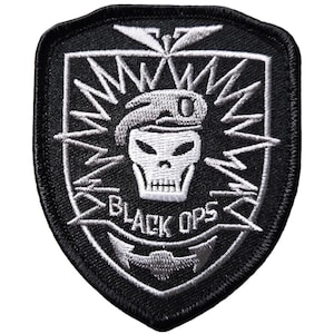 May include: Black and white embroidered patch with a skull wearing a beret and the words "Black Ops" on a black background.