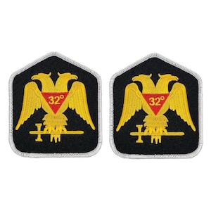 May include: Two black and gold embroidered patches with a white border. Each patch features a two-headed eagle with a red triangle containing the number 32 degrees.