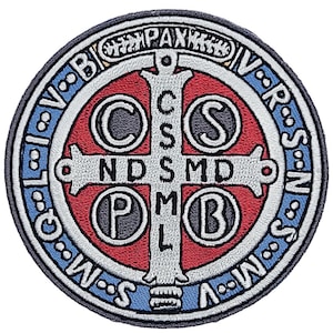 May include: A round, embroidered patch with a white cross and four circles. The circles contain the letters "C", "S", "P", and "B". The cross has the letters "NDSMD" on it. The patch is surrounded by a blue and white border with the words "INRI" and "V.R.S.S.N.W.S." in a circle.
