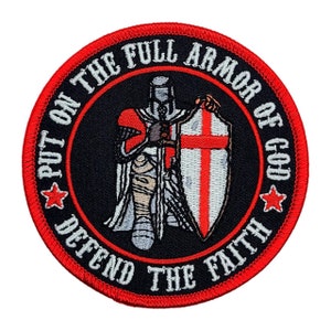 May include: A red, white, and black embroidered patch with a knight in armor holding a sword and shield. The text on the patch reads "Put on the Full Armor of God Defend the Faith".