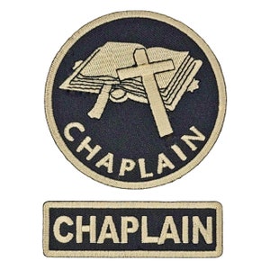 May include: Two embroidered patches with the word "CHAPLAIN" in beige thread on a black background. The larger patch features a beige cross over an open book.