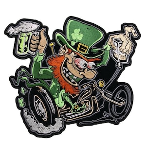 May include: A green leprechaun with a red beard riding a motorcycle and holding a green beer mug. The motorcycle has a black frame and a black seat. The leprechaun is wearing a green hat with a shamrock on it.