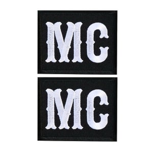 May include: Two black embroidered patches with white lettering that reads "MC".