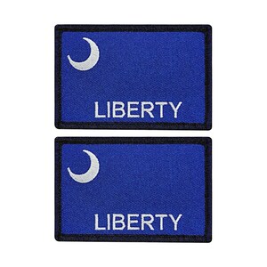 May include: Two blue and white embroidered patches with the word "LIBERTY" and a crescent moon design. The patches have black borders.