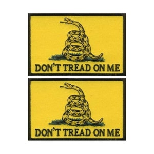 May include: Two yellow embroidered patches with a black border. Each patch features a coiled rattlesnake with a green background and the text "DON'T TREAD ON ME".