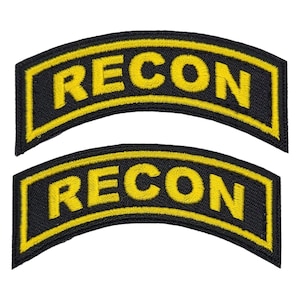 May include: Two black and yellow embroidered patches with the word "RECON" in yellow lettering.