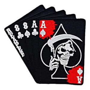 May include: Black and white embroidered patch of the Ace of Spades with a Grim Reaper holding a scythe. The card is surrounded by four other cards, two 8s of clubs and two Aces of clubs. The patch has red blood splatter on it.