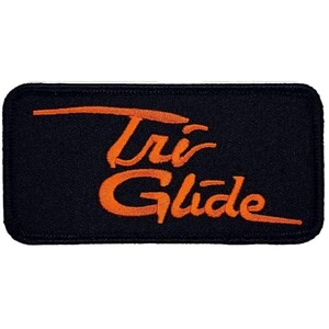 May include: Orange embroidered "Tri-Glide" patch on a black background.