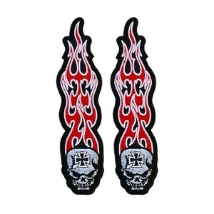 May include: Two black and red embroidered iron-on patches featuring a skull with a cross on its forehead and flames behind it.
