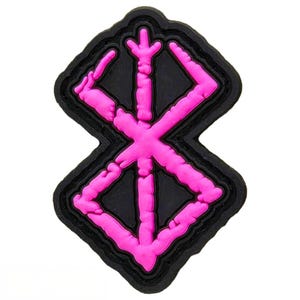 May include: Pink and black iron-on patch with a stylized symbol, resembling a cross with four points, with a rough, textured surface.