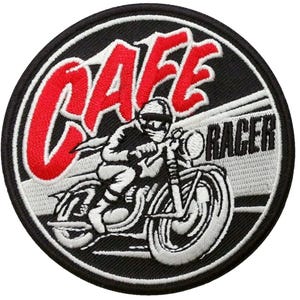 May include: A black and white embroidered patch with a red "CAFE RACER" logo. The patch features a stylized image of a motorcycle rider in a helmet, riding a motorcycle.
