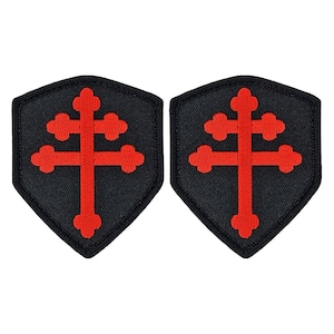 May include: Two black embroidered patches in the shape of a shield with a red cross with four smaller crosses on each side.