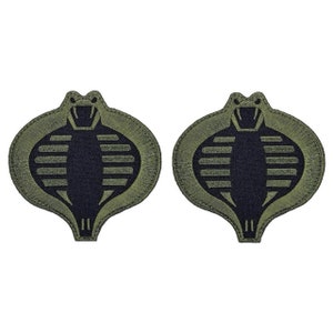 May include: Two green fabric patches with a black cobra design. The cobra is in a raised, embroidered style.