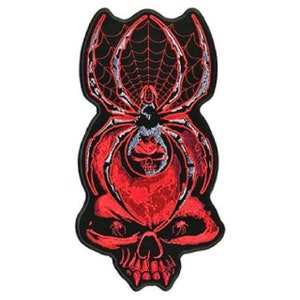 May include: Red embroidered patch with a black spider with a skull in its web. The spider is on top of a red skull with black eyes.