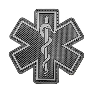 May include: A black and white star of life patch with a snake and staff symbol in the center. The patch has a textured surface and is surrounded by a black stitched border.
