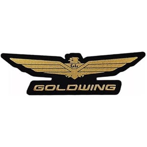May include: A black and gold embroidered patch with a stylized eagle and the text "GOLDWING".