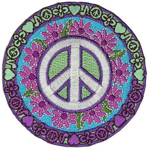 May include: A white peace sign with a purple outline surrounded by a wreath of pink flowers on a blue background. The background is surrounded by a brown border with purple hearts, flowers, and peace signs.