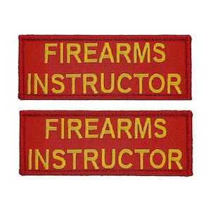 May include: Two red embroidered patches with the text "FIREARMS INSTRUCTOR" in yellow thread.