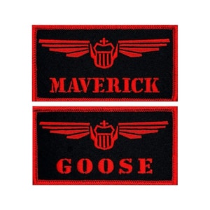 May include: Two black rectangular patches with red embroidered text and design. The top patch reads "MAVERICK" and the bottom patch reads "GOOSE". Each patch features a red emblem of wings and a crest.