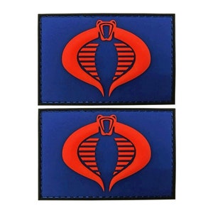 May include: Two blue and black embroidered patches with a red cobra logo. The cobra is a stylized snake with a red head and a red body with black stripes.