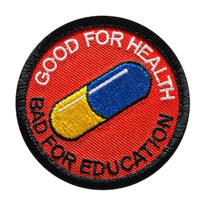 May include: A red, white, and blue pill-shaped patch with the text "Good for Health Bad for Education" in white embroidery.