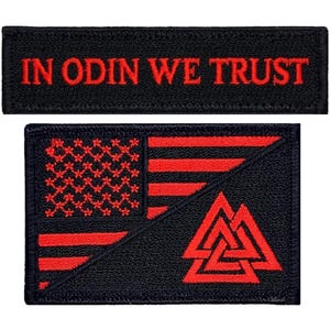 May include: Two black embroidered patches. The top patch reads "IN ODIN WE TRUST" in red. The bottom patch features a red and black design with an American flag and a symbol. The flag has red stripes and red stars. The symbol is a red triangle.