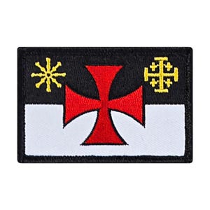May include: A black and white embroidered patch with a red cross in the center. The patch has a yellow sunburst design in the top left corner and a yellow cross with four smaller crosses in the top right corner.